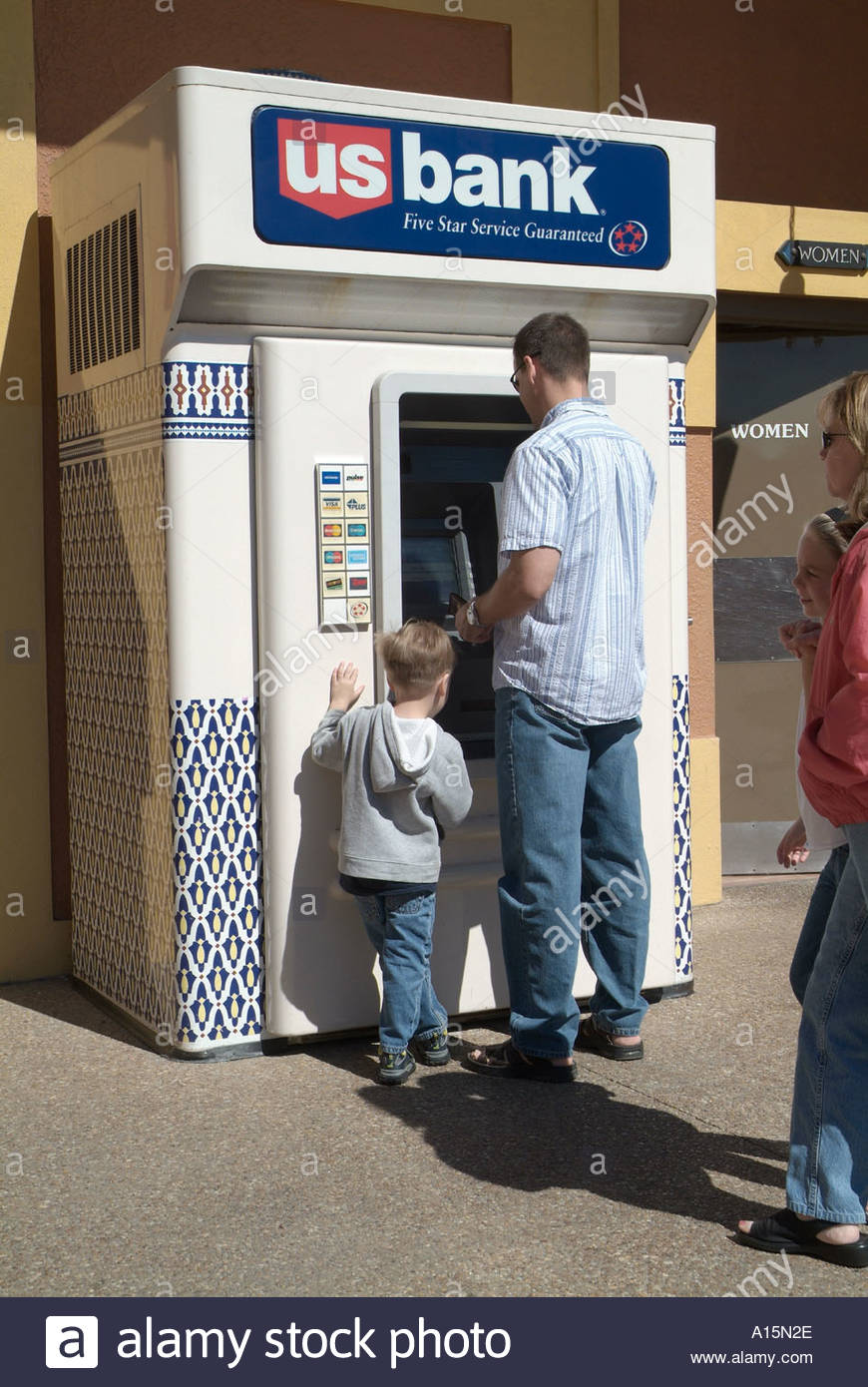 870x1390 People Drawing Money From An Atm Machine Stock Photo 3313965