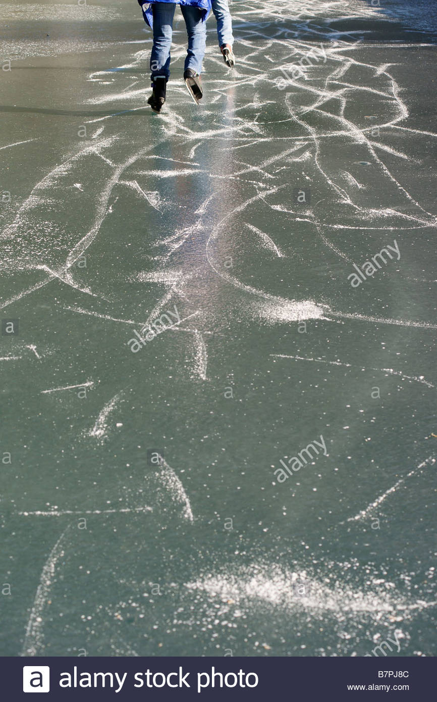 866x1390 Two Skaters Skating On Thick Ice Drawing Lines Curved On Frozen