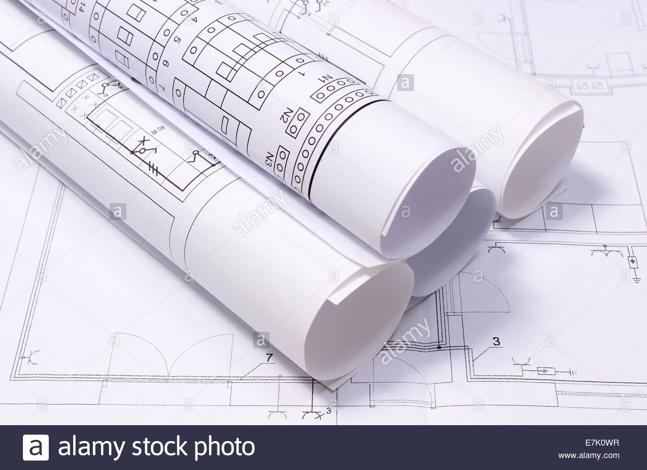 1300x944 Rolled Electrical Diagrams Lying On Construction Drawing Of House