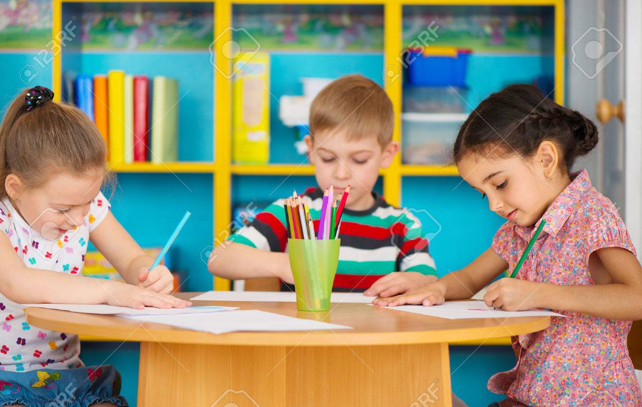1300x825 Three Cute Preschool Children Drawing At Daycare Stock Photo