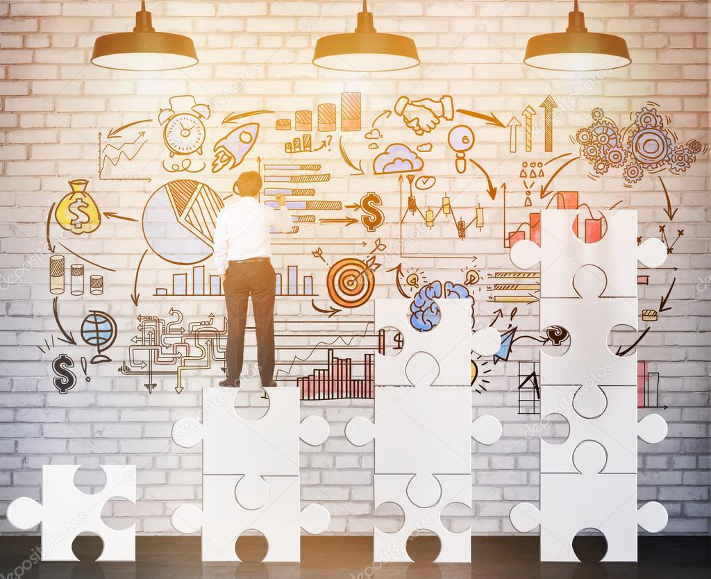 1024x834 Rear View Of Businessman Standing On Puzzle Pieces And Drawing