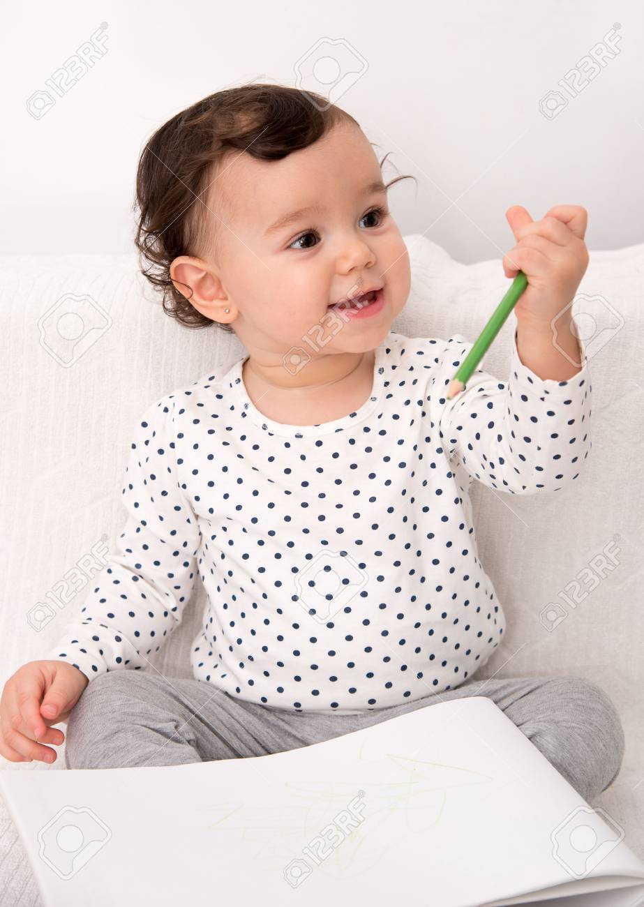 923x1300 Smiling Baby Girl Sitting On The Bed And Drawing With A Colored