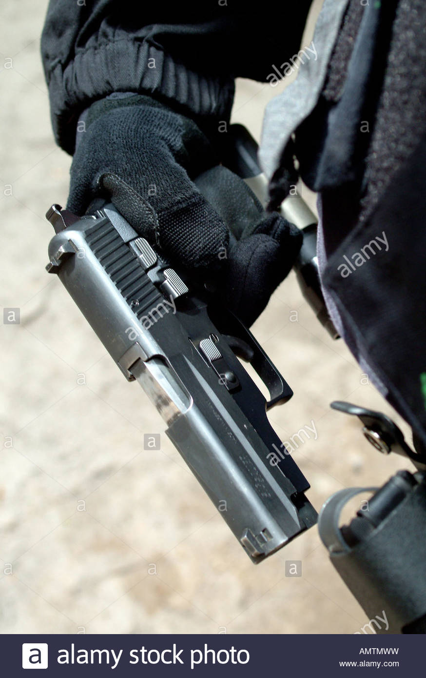 874x1390 Hand Of A Swat Team Member Drawing His Weapon Stock Photo