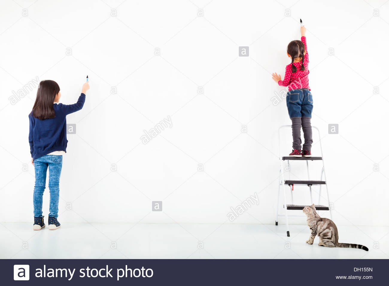 1300x956 Two Kids Drawing On The Blank White Wall Stock Photo, Royalty Free