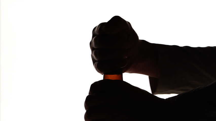 852x480 The Silhouette Of Male Hands Opening Brown Beer Bottle Stock