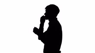 320x180 Man Inflates Balloon For Celebration. Silhouette. White Stock