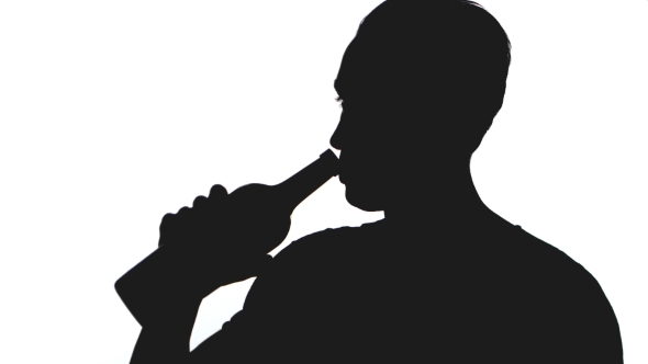 590x332 Silhouette Of Young Man Drinks Alcohol From A Bottle Isolated