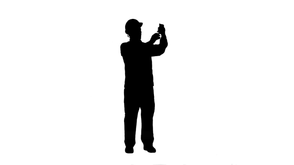590x332 Silhouette Construction Engineer In Helmet Makes Selfie On