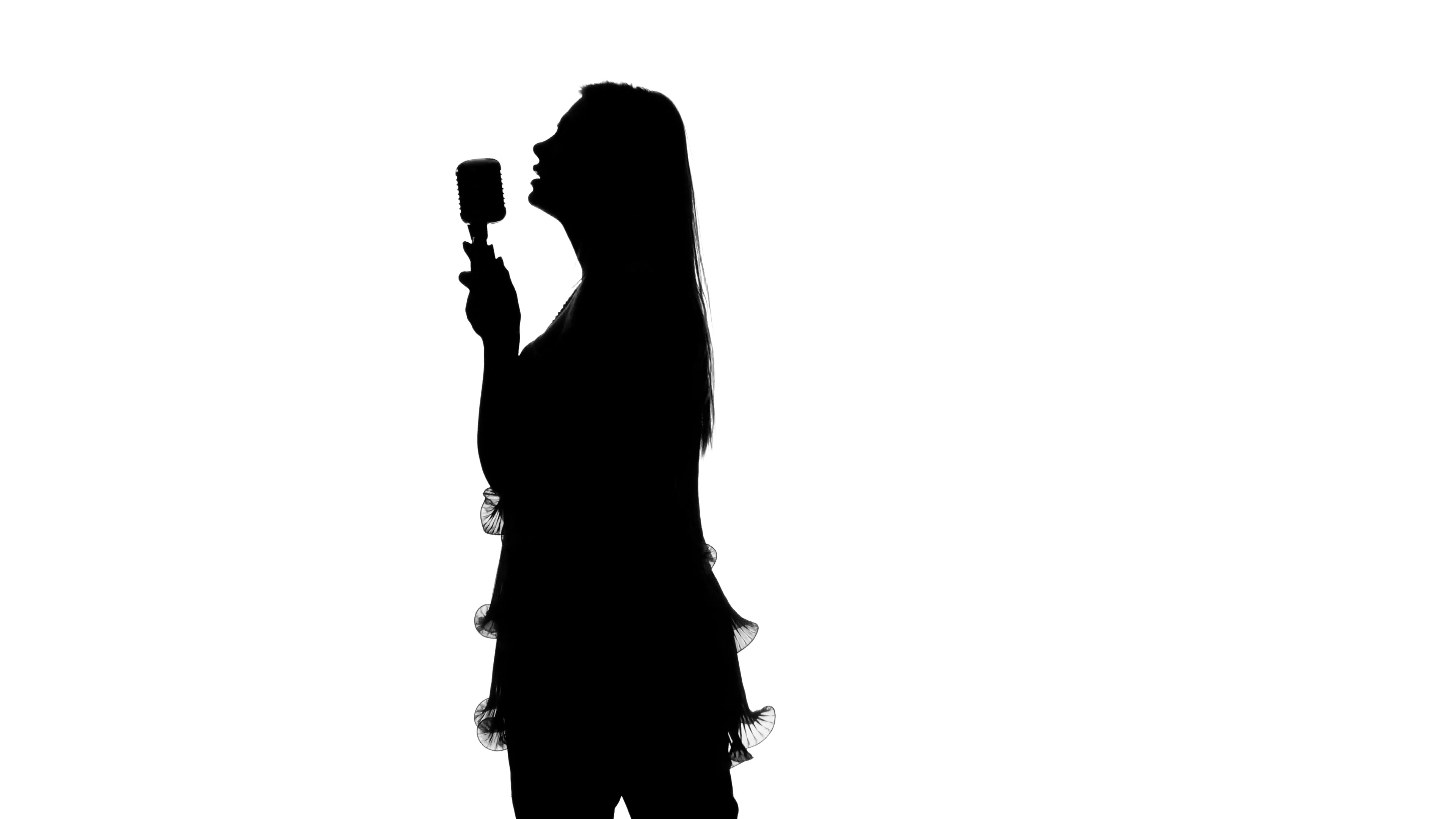 3840x2160 Girl In Short Dress Singing The Song In The Hall. Silhouette