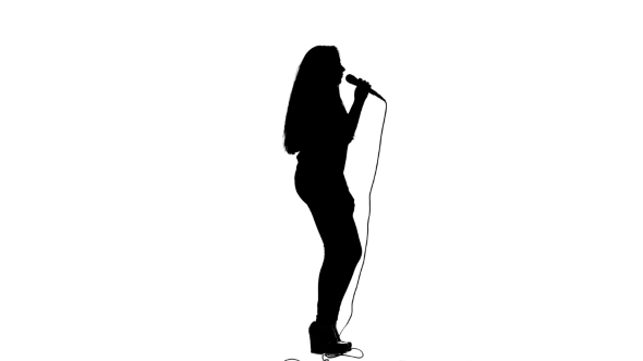 590x332 Girl Dances To The Beat Of Her Song. White Background. Silhouette