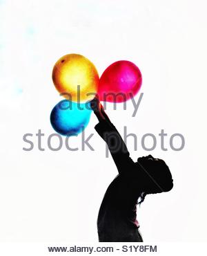 300x370 Silhouette Of A Girl Holding Bunch Of Balloons Stock Photo