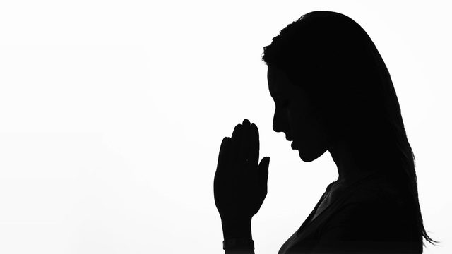 640x360 Closeup Profile Of A Woman Praying In Silhouette Isolated Stock