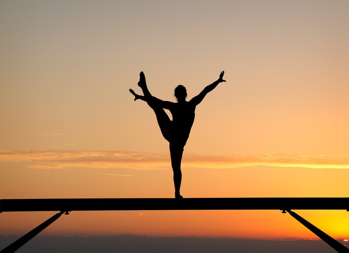 700x508 Silhouette Of Female Gymnast On Balance Beam In Sunset Wall Mural