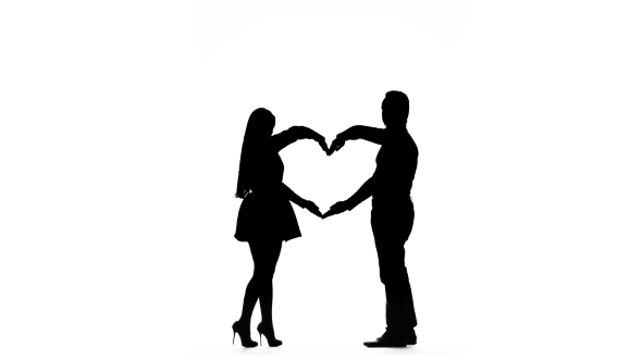 590x332 Loving Couple Makes A Heart Shape With The Help Of Hands