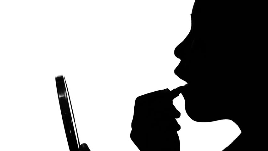 852x480 Silhouette Of Woman Paints Her Lips With Lipstick On A White