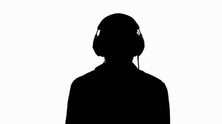 320x180 Silhouette Of A Girl Listening To Music On Headphones. Black
