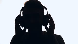 320x180 Female Silhouette With Headphones, Young Woman Listening To Music