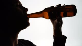 320x180 The Silhouette Of Male Head Drinking From A Aluminum Can Stock