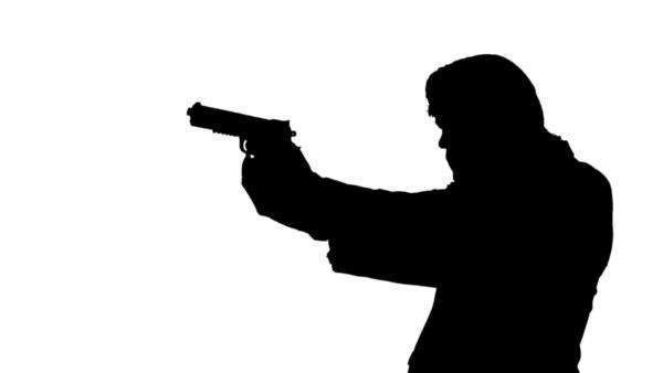 600x338 Silhouette Of A Man With A Gun Walking And Aiming Down The Sights