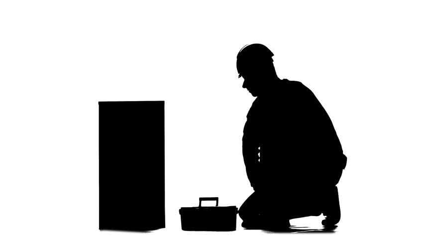 852x480 Builder In A Helmet Hammers A Nail With A Hammer. Silhouette