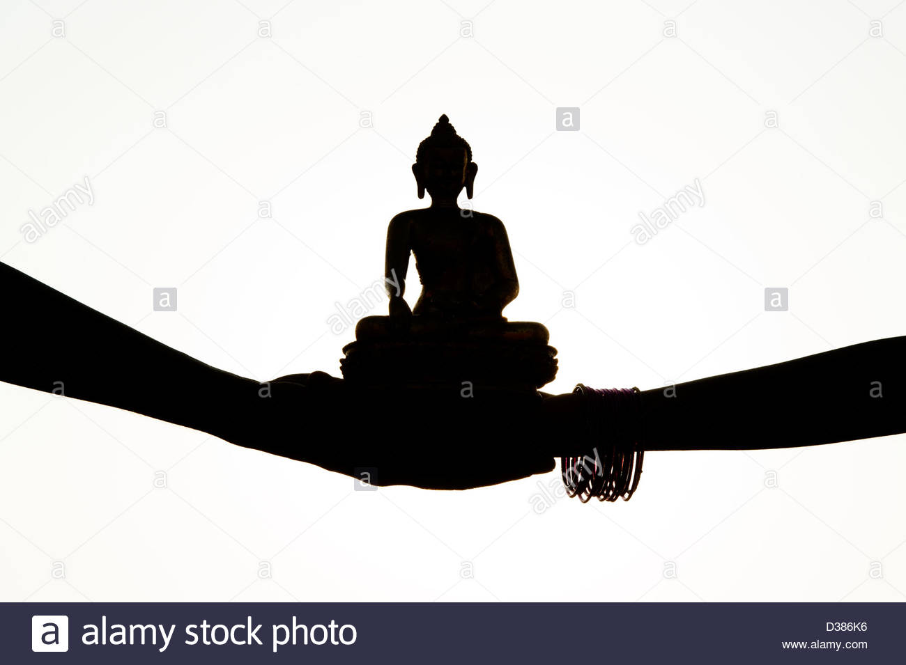 1300x955 Indian Hands Holding A Buddha Statue. Silhouette Stock Photo