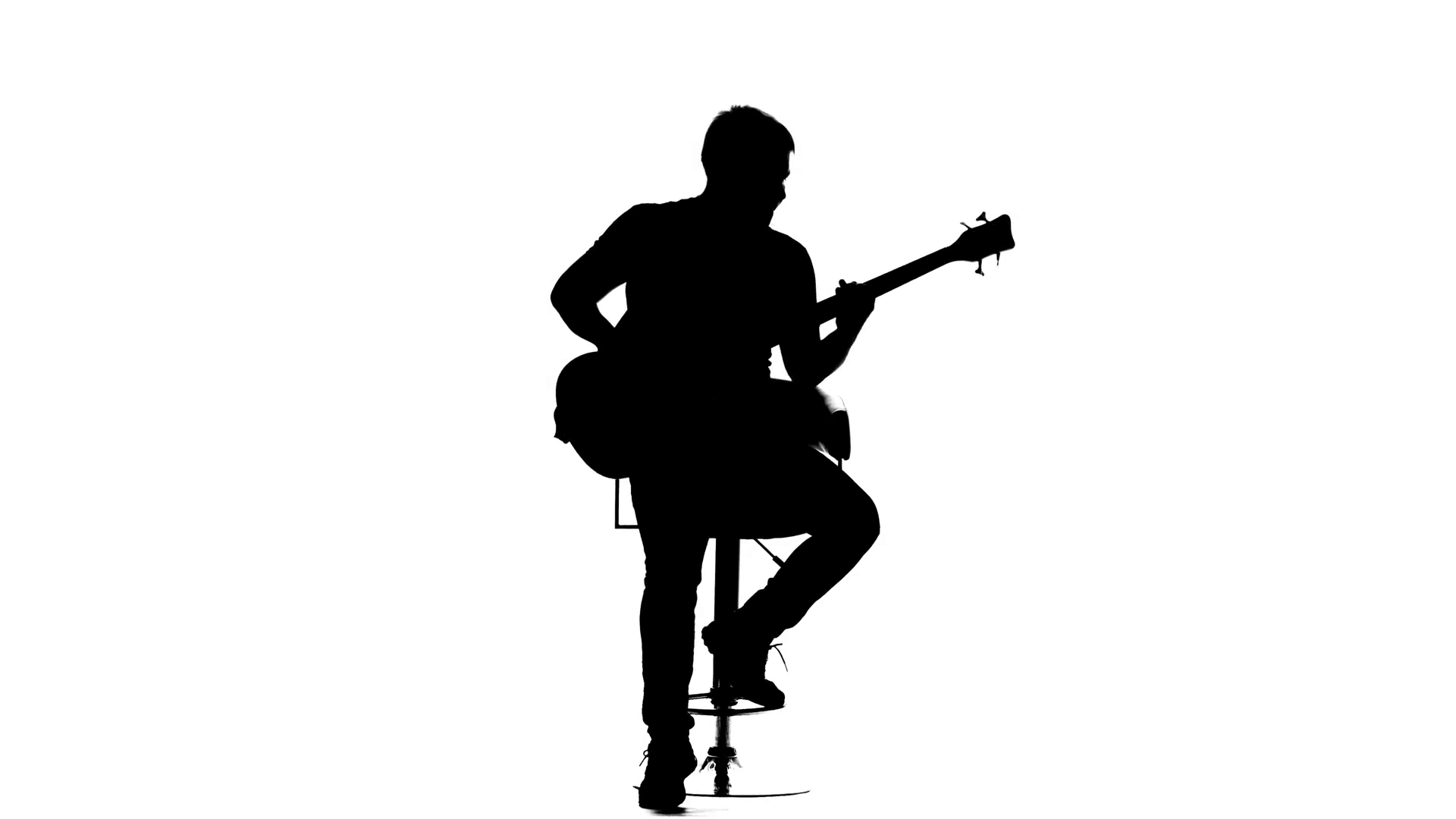 1920x1080 Man Plays Bass Guitar While Sitting On A Chair. Silhouette Stock