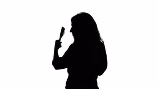 320x180 Ms Young Woman Combing Hair, Studio Shot Stock Video Footage