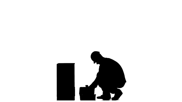 590x332 Builder In A Helmet Hammers A Nail With A Hammer. Silhouette