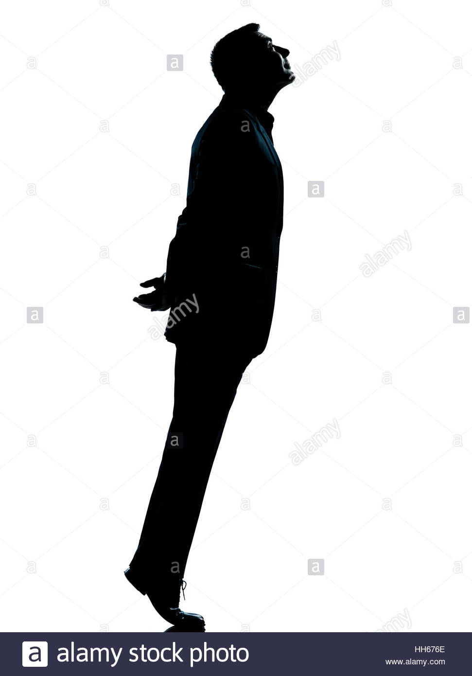 971x1390 One Caucasian Business Man Silhouette Standing Tiptoe Looking Up