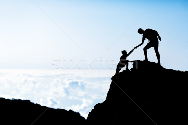 600x400 Man And Woman Help Silhouette In Mountains Stock Photo