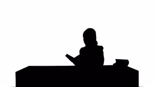 320x180 Female Silhouette Reading A Book Stock Video Footage