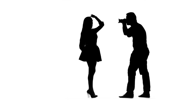 590x332 Model Girl Posing For A Photographer. Silhouette. White Background