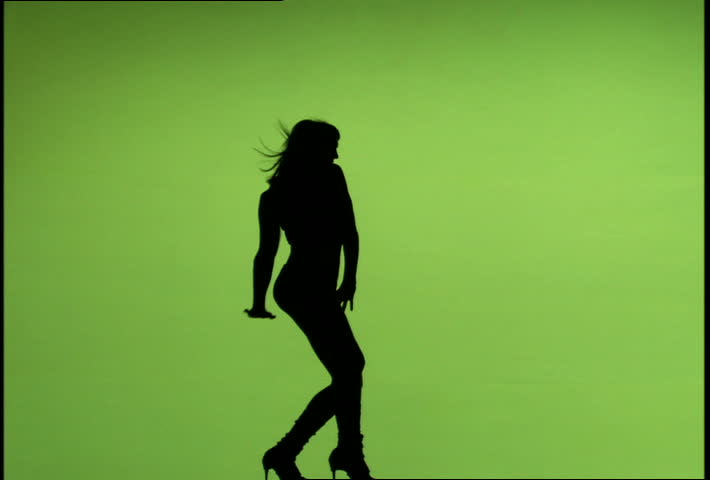 710x480 Woman's Silhouette Dancing Against A Green Screen Background Stock