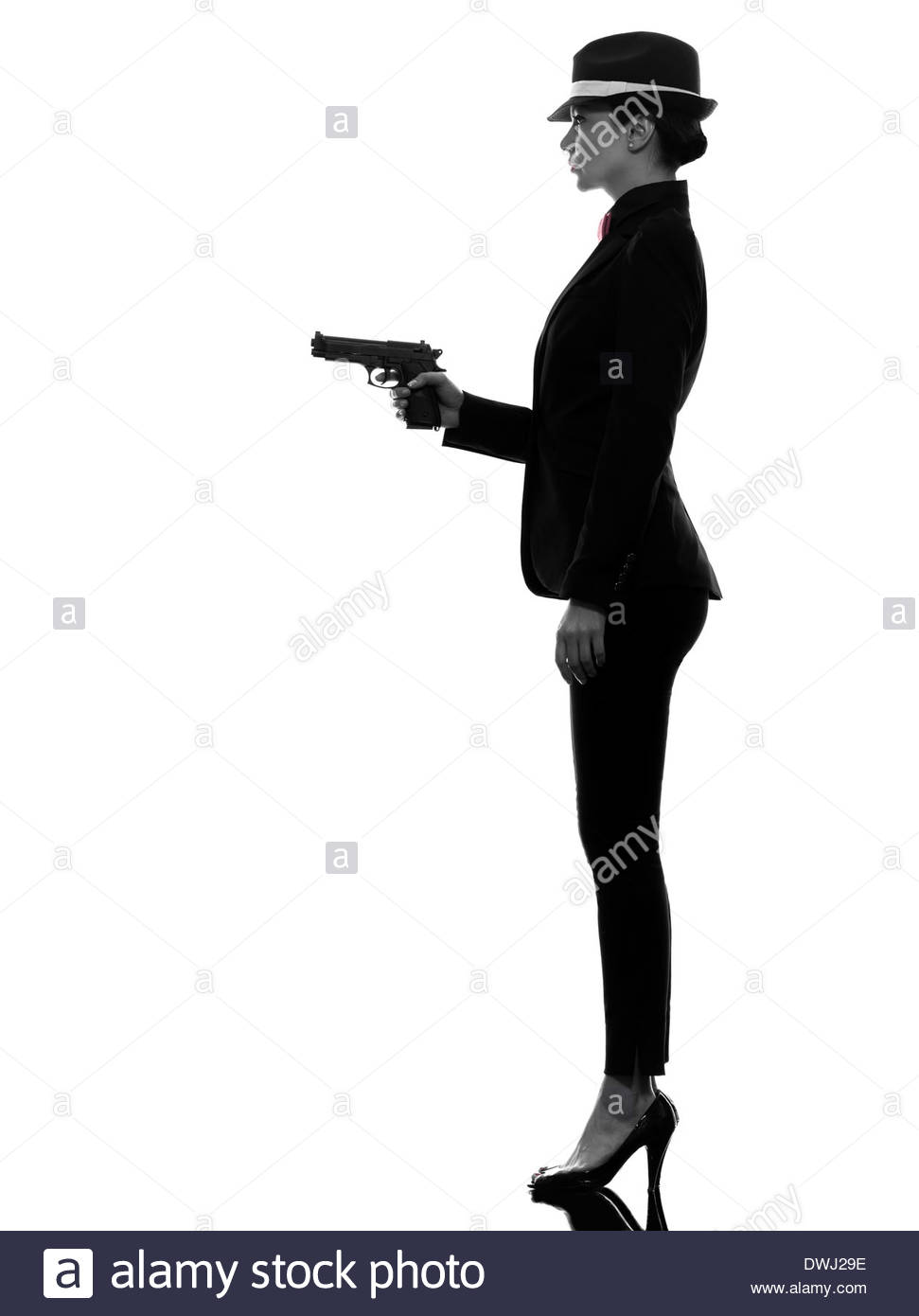 971x1390 One Stylish Woman In Suit Holding Gun In Silhouette On White Stock