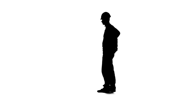 590x332 Worker In A Helmet Hammers A Nail With A Hammer. Silhouette. White