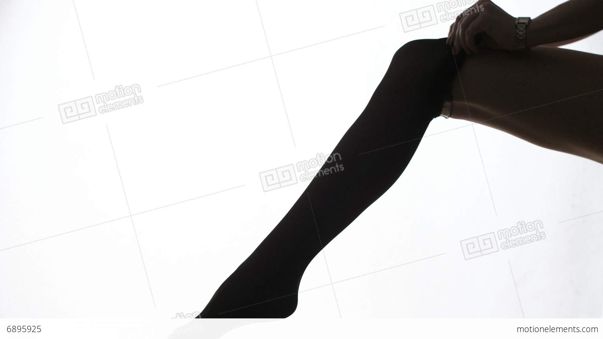 1920x1080 Lady Puts On Stockings In Silhouette Stock Video Footage 6895925