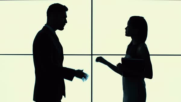 600x338 Silhouette Of Business Man And Woman Shaking Hands And Talking