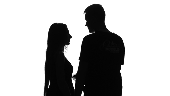 590x332 Romantic Couple. Portrait Of Two People Kissing. Silhouette. White