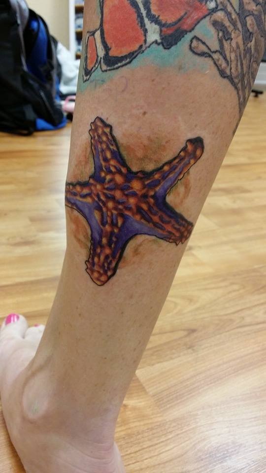540x960 Colorful Starfish Tattoo On Back Leg